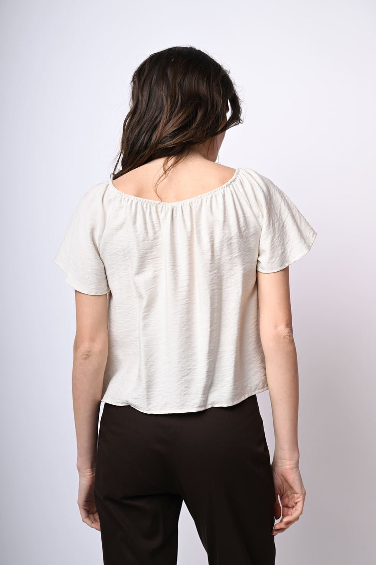 Top a spalle scoperte con bottoni