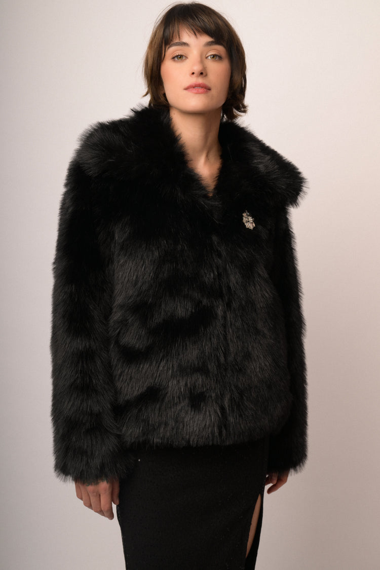 Giacca in faux fur nera con spilla gioiello