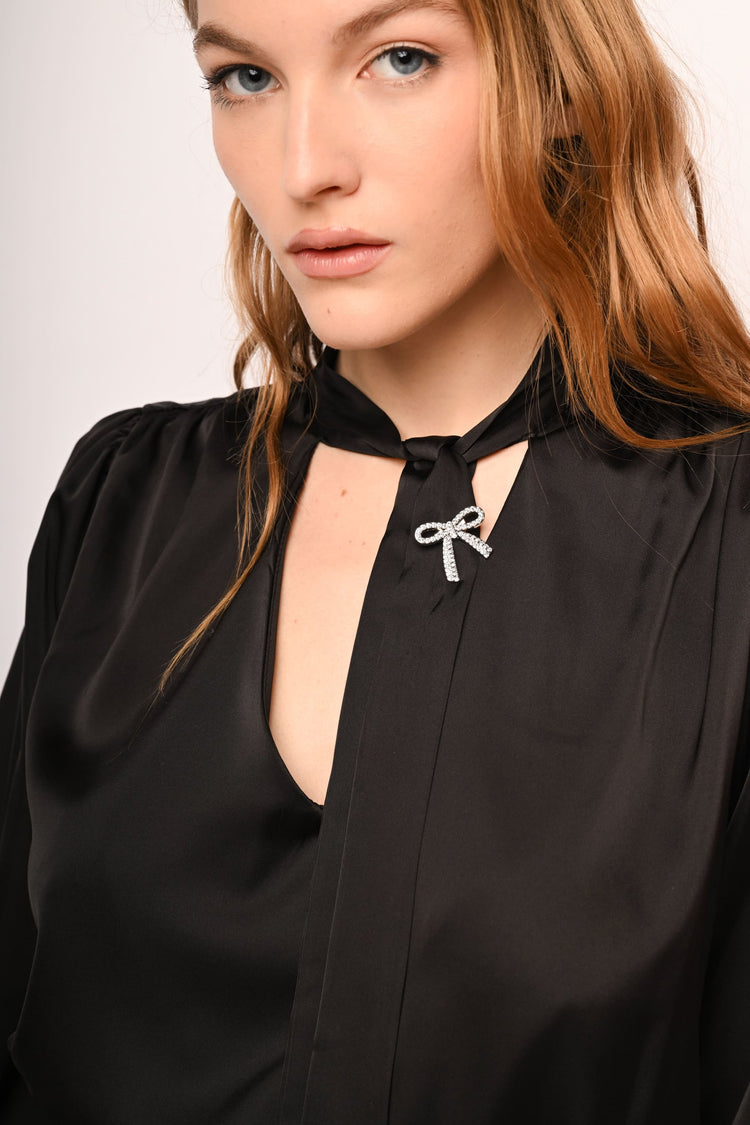 Blusa in raso con laccio e spilla