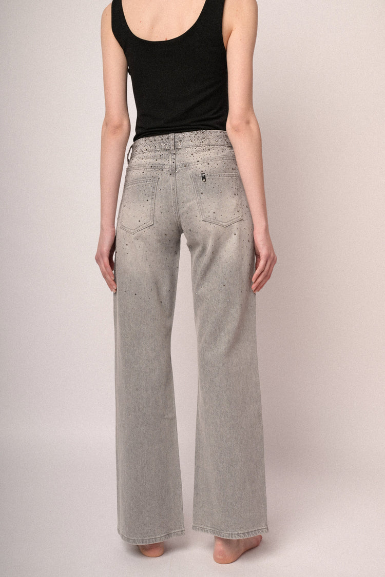 Jeans a a gamba ampia in denim grigio con decorazione strass