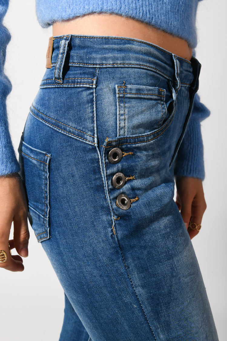 Jeans skinny con bottoni sulle tasche