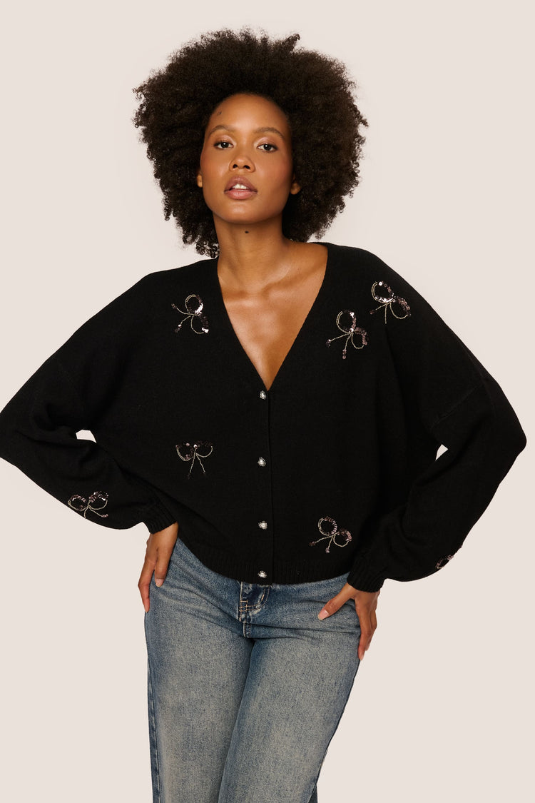 Cardigan con fiocchi in paillettes