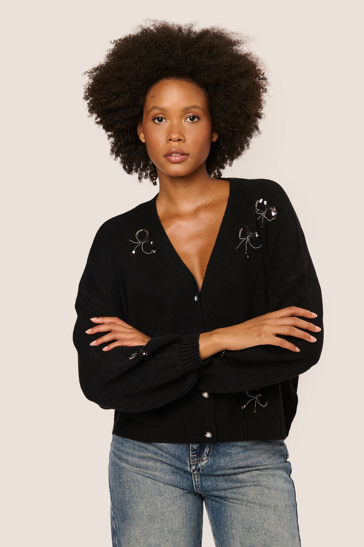 Cardigan con fiocchi in paillettes