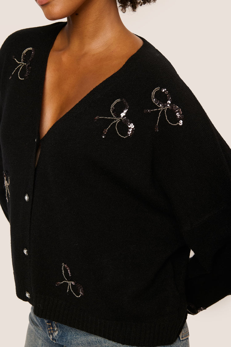 Cardigan con fiocchi in paillettes