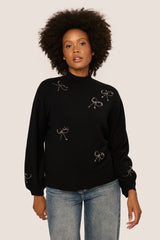 Lupetto con fiocchi in paillettes