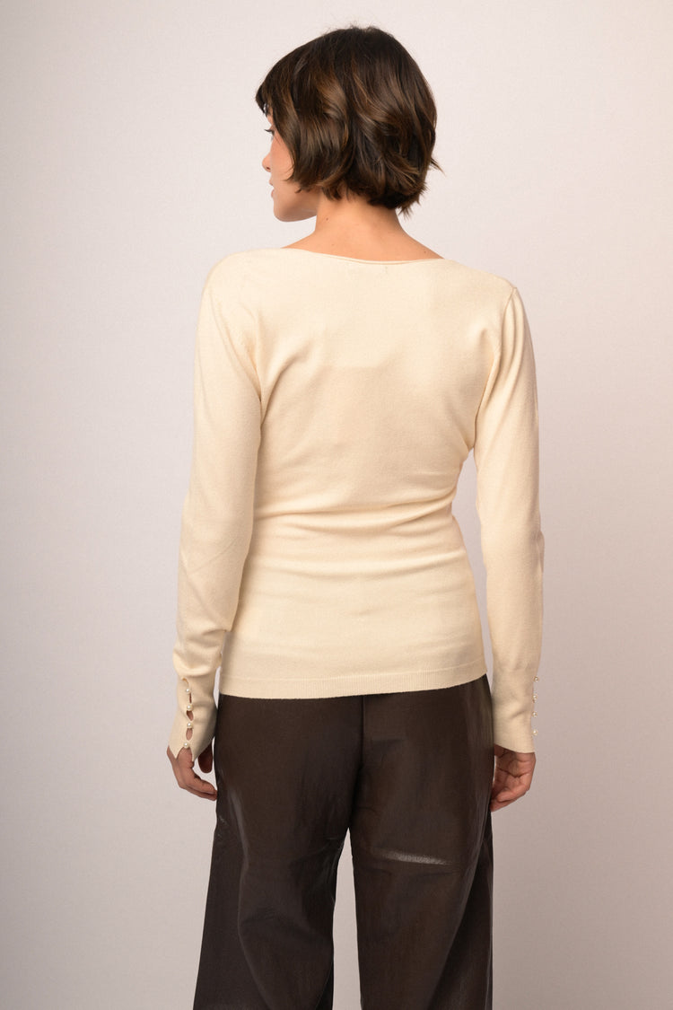 Pull incrociato avorio con fiocchetto in perline